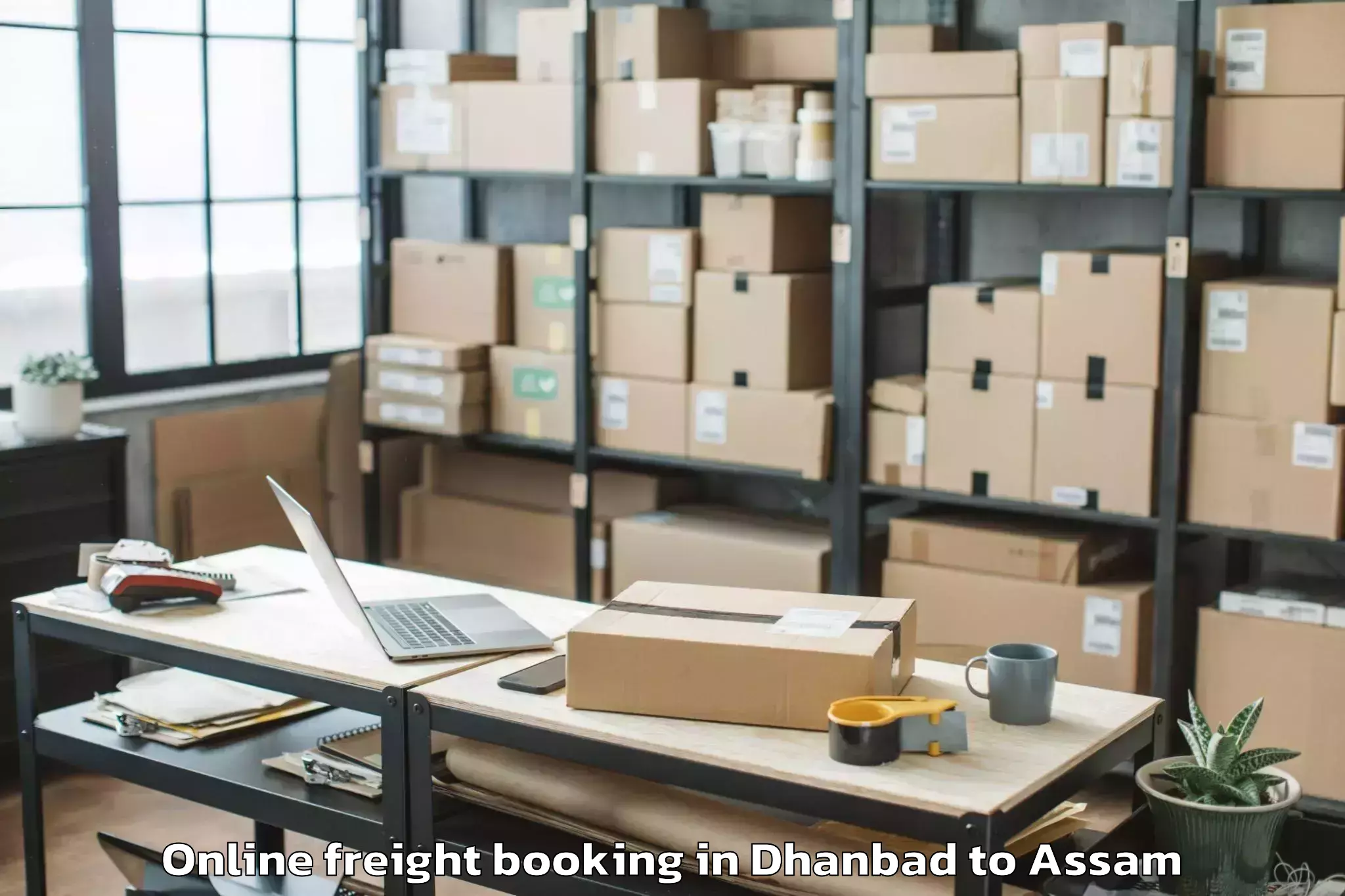 Book Dhanbad to Sualkuchi Online Freight Booking